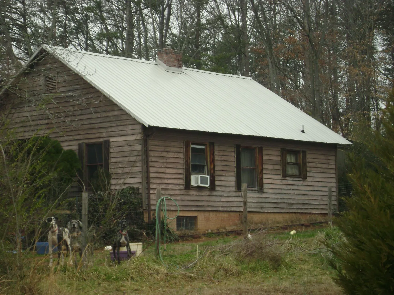 White metal roof on an old wood sided farmhouse, from a Metal Roof Installation job in Garden Grove